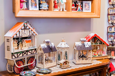 small wooden christmas decorations in the style of snowy villages