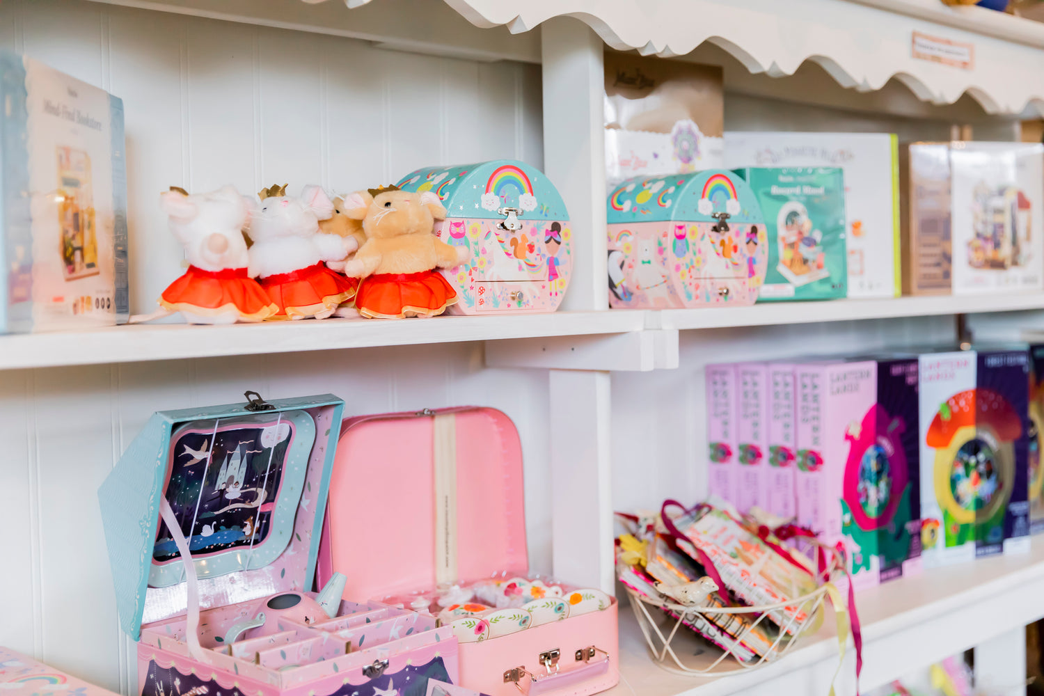 puzzles, little stuffed animals for children and lunch box styled containers on a shelf