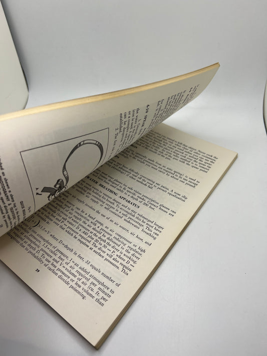 A 1961 Vintage AFM Emergency Rescue manual with an open page on a white surface.